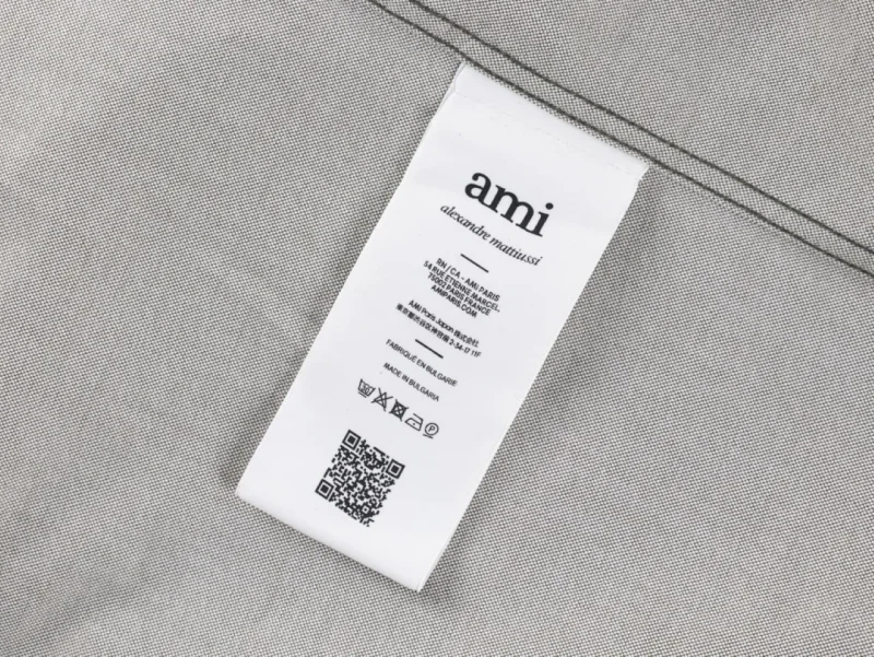White label, likely cotton material, showing care instructions.
