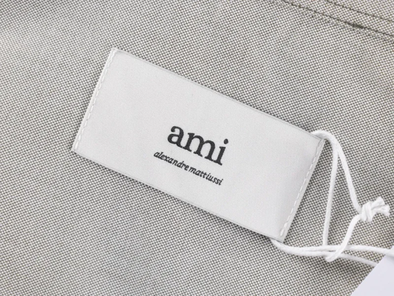 Label on a textured gray material with attached white string.