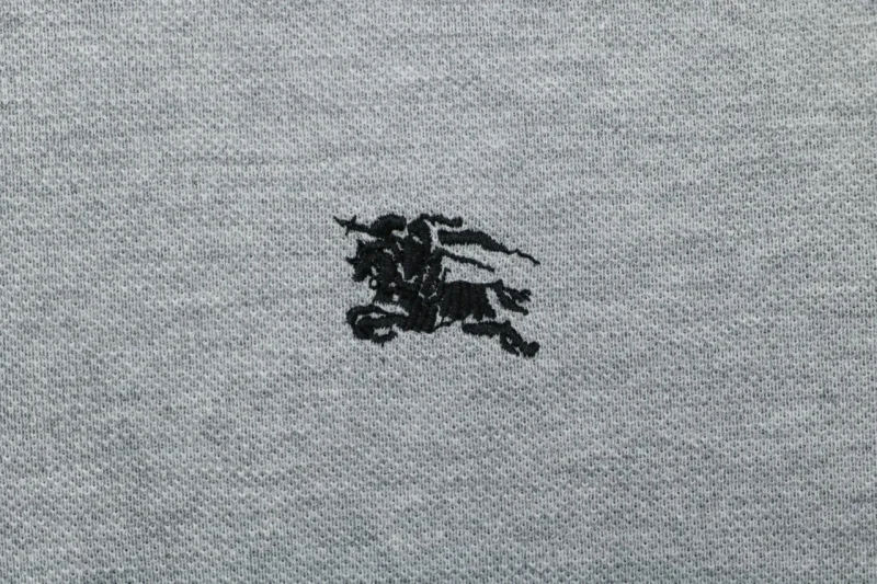 Black embroidered knight design, close-up detail.