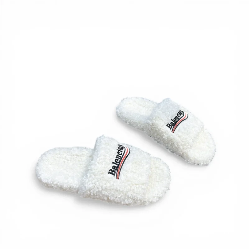 Pink fluffy slippers with embroidered logo on the upper, providing comfort and style.
