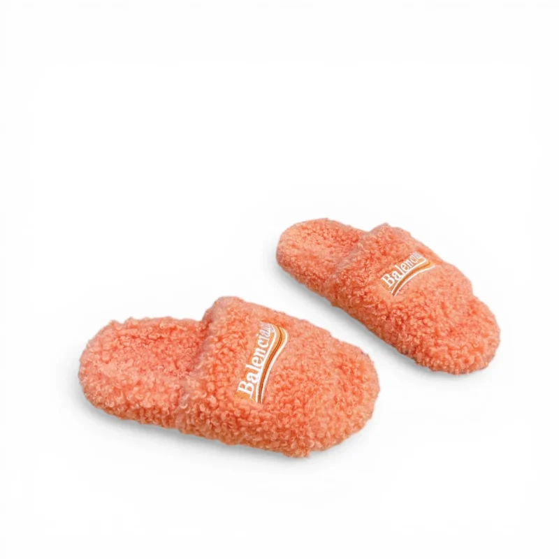 Orange fluffy slippers with open toes, made from soft, textured fabric.