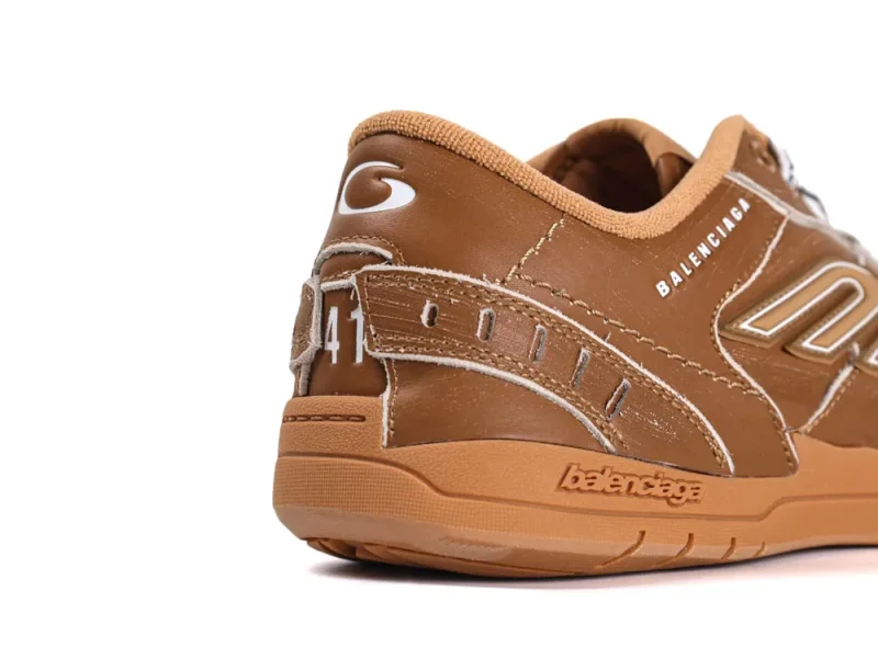 Brown leather sneaker with logo detailing on heel and side.