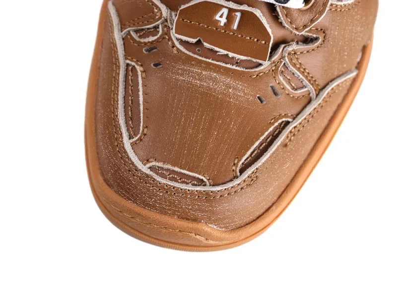 Brown leather shoe upper with white stitching and size 41 label.