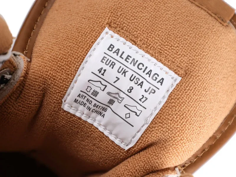 Brown fabric shoe interior with a Balenciaga size label and stitching details.