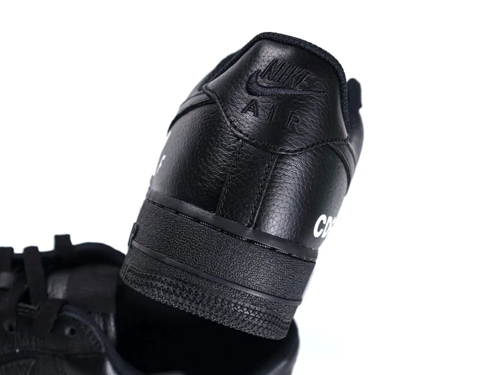 Black leather sneaker with embossed logo on the heel section.