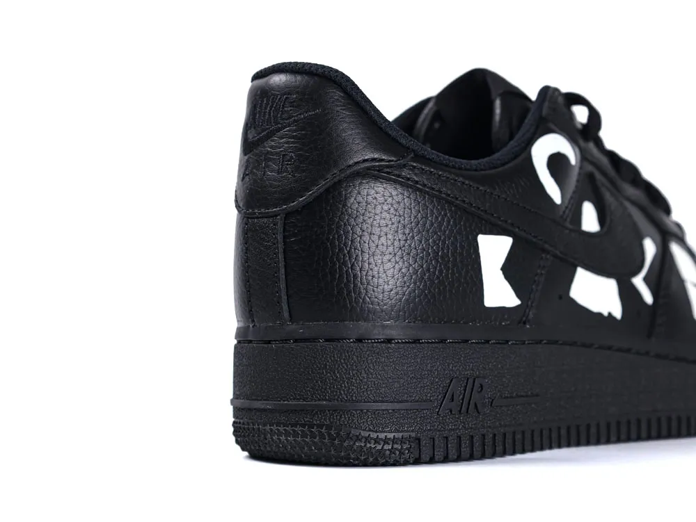Black leather sneaker with a textured finish and bold white accents.