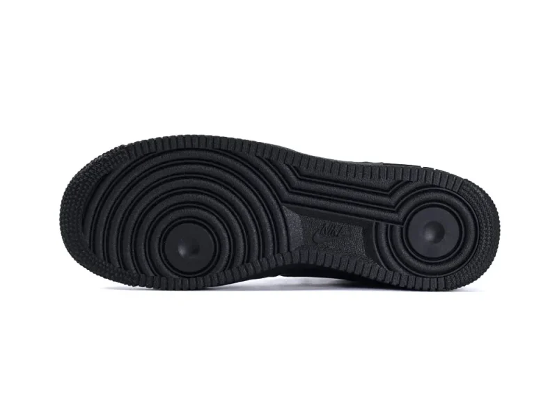 Black rubber outsole with circular tread pattern, designed for grip and durability.