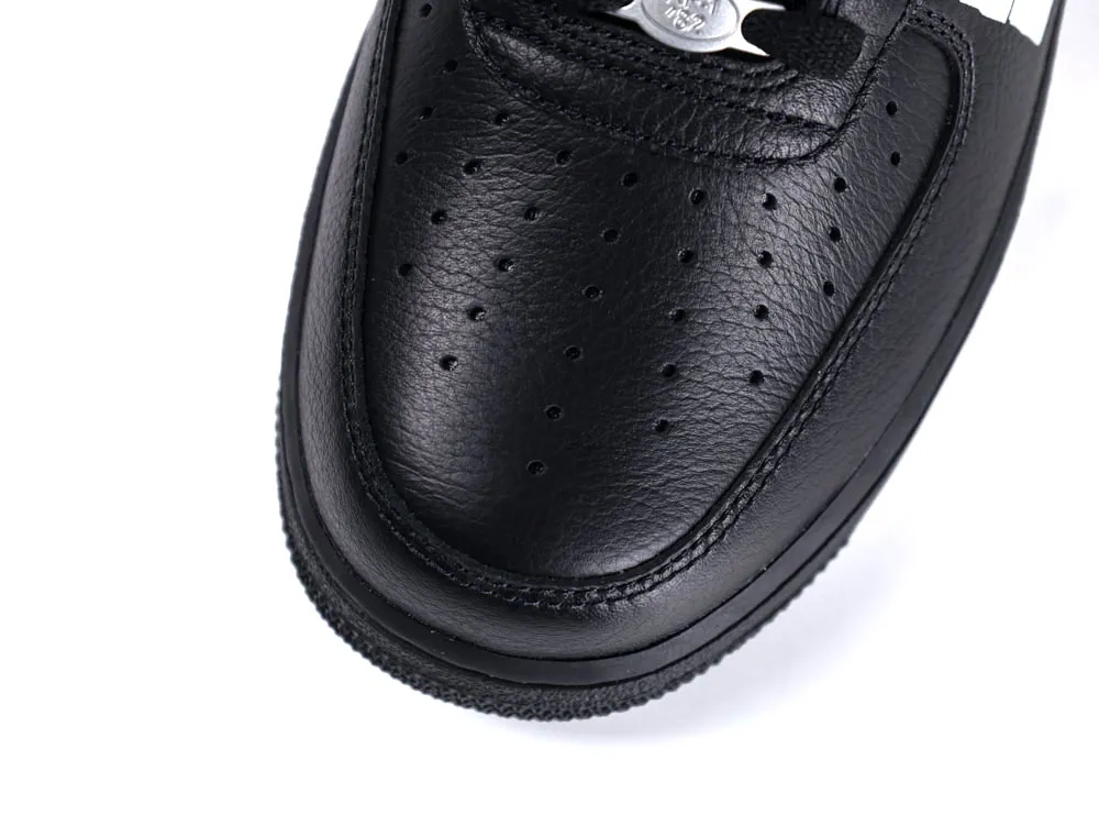 Black leather shoe with perforated design on the toe area.