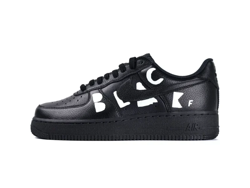 Black leather sneaker with perforated toe box and white letters on the side.