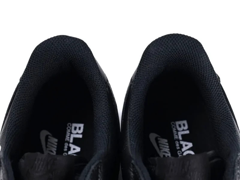 Black fabric lining inside sneakers with visible branding on the insole.