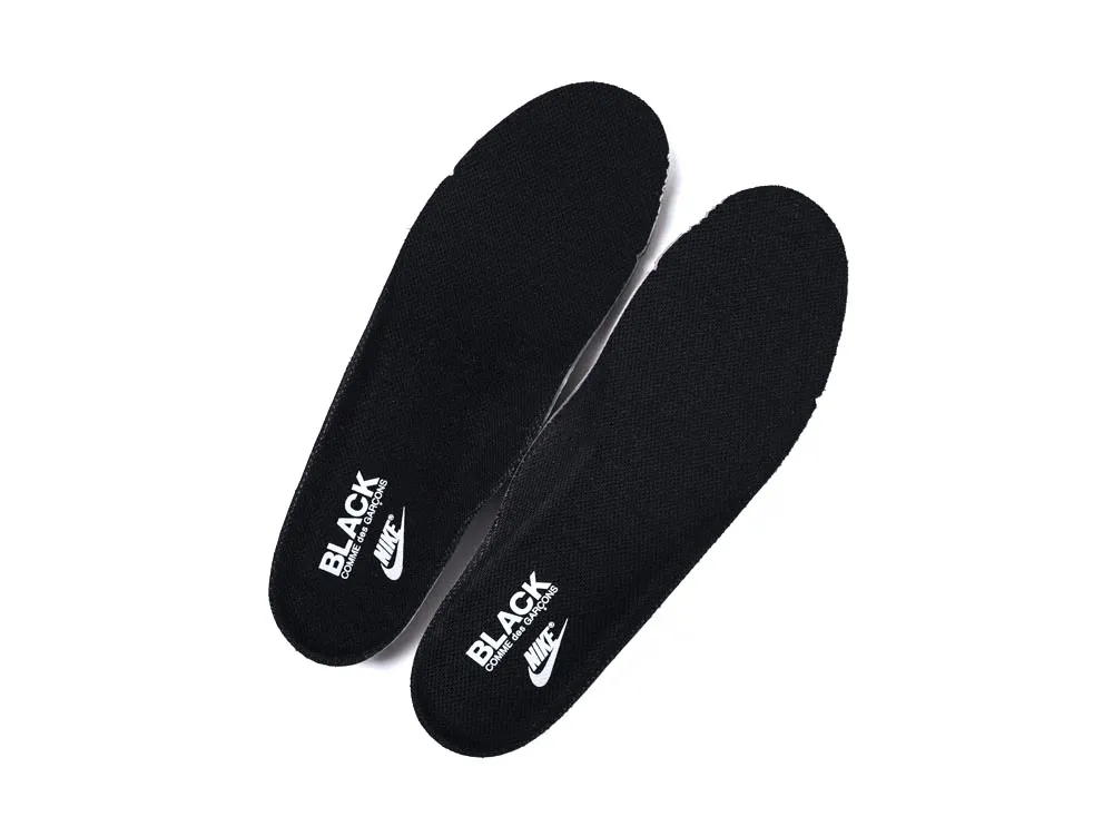 Black fabric shoe insoles with white logos, designed for comfort and support.