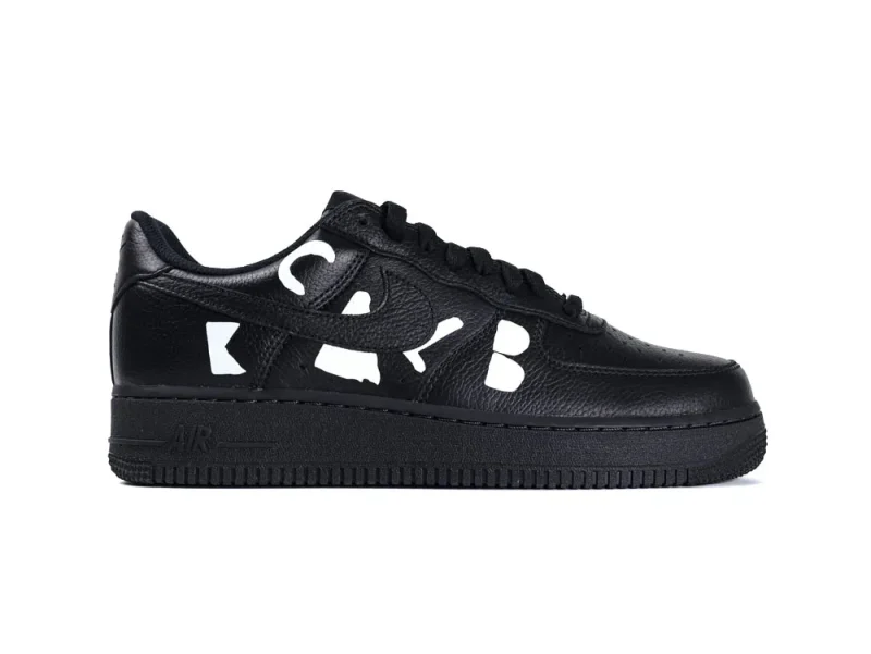 Black leather sneaker with cutout designs on the side and black sole.