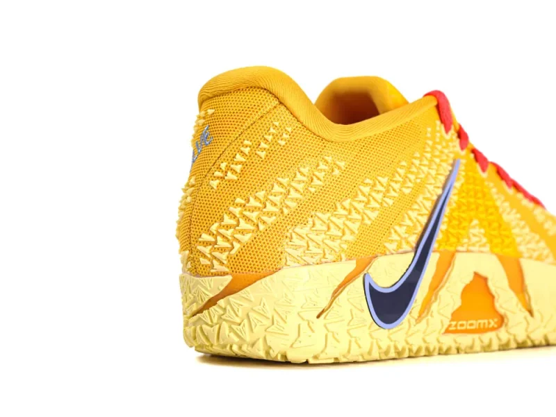Yellow mesh sneaker with textured rubber sole and blue accent detailing.