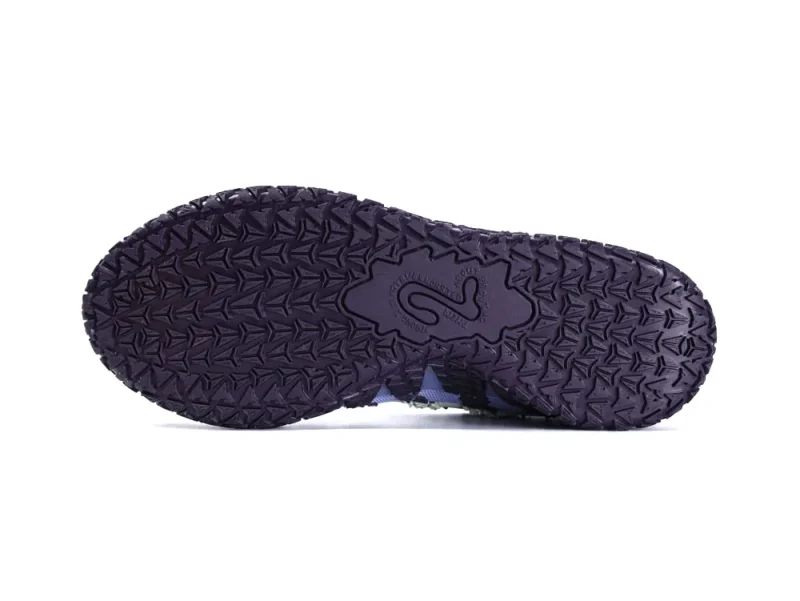 Dark purple rubber sneaker sole with textured grip pattern, showing durability and design.