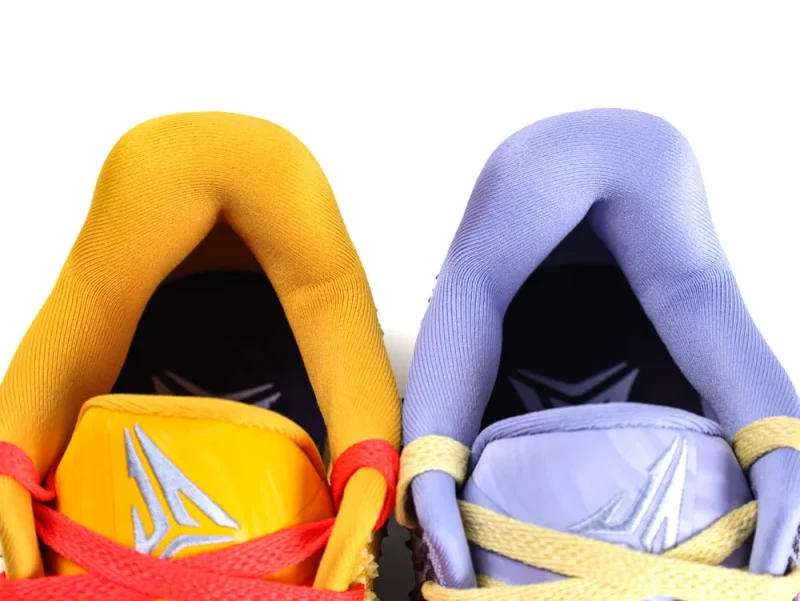 Yellow and purple sneakers with padded fabric collars and contrasting laces.