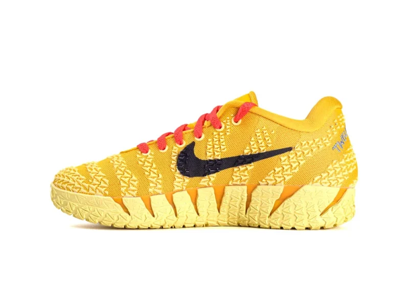 Yellow mesh sneaker with red laces, textured sole, and black logo detail.