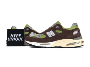 Brown and green suede sneakers with mesh detailing and cushioned sole.