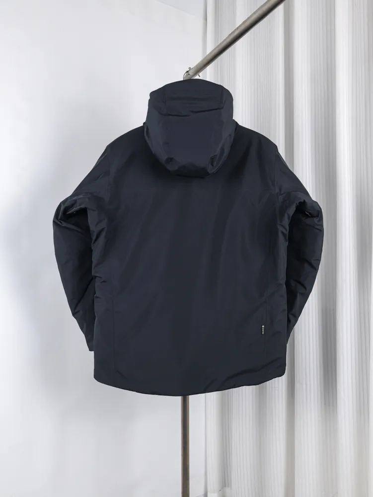 Hooded jacket made of synthetic material, shown from the back.