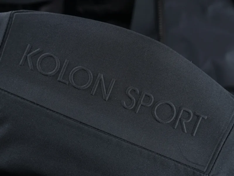 Dark fabric featuring embossed text with the brand name "KOLON SPORT"