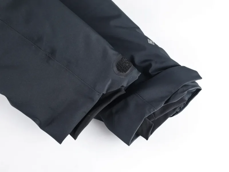 Jacket sleeve with strap and cuff detail.