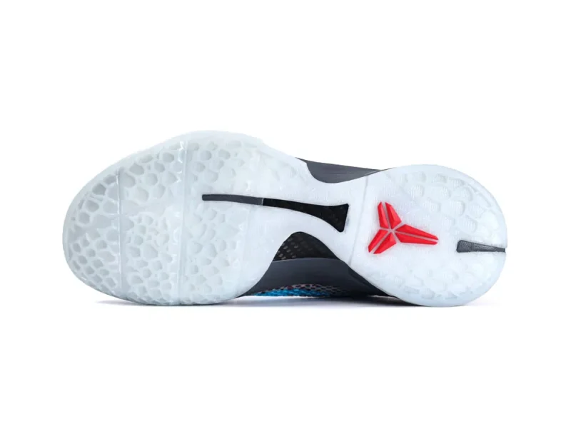 White, rubber sole of a shoe with red logo and textured grip pattern.