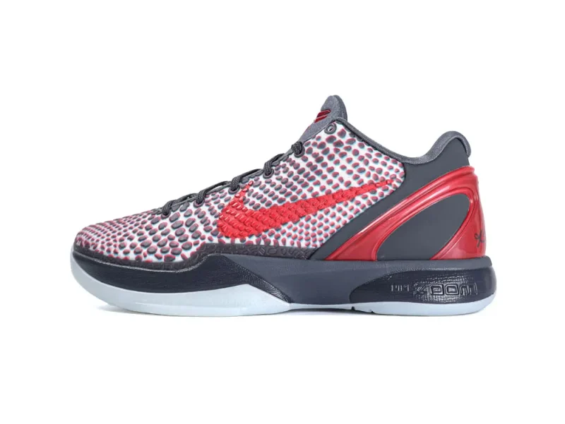Gray and red sneaker with textured fabric upper and rubber sole.