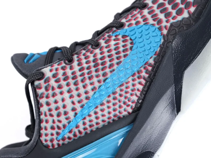 Close-up of sneaker with blue logo, textured fabric, and black laces.