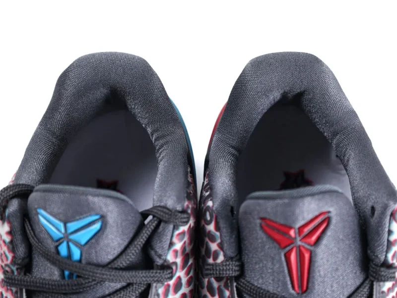 Alt text: Black and grey sneakers with blue and red logo accents on tongues.