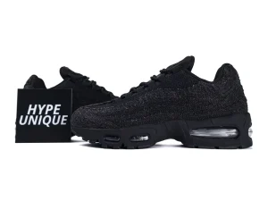 Black mesh sneakers with visible air cushioning in the sole, displayed on white background.