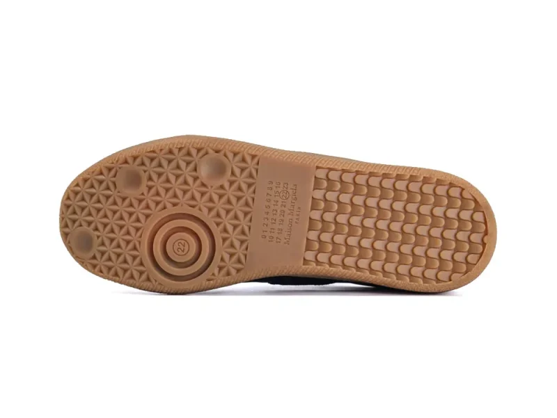 Tan rubber sole with circular and rectangular patterns, textured for grip.