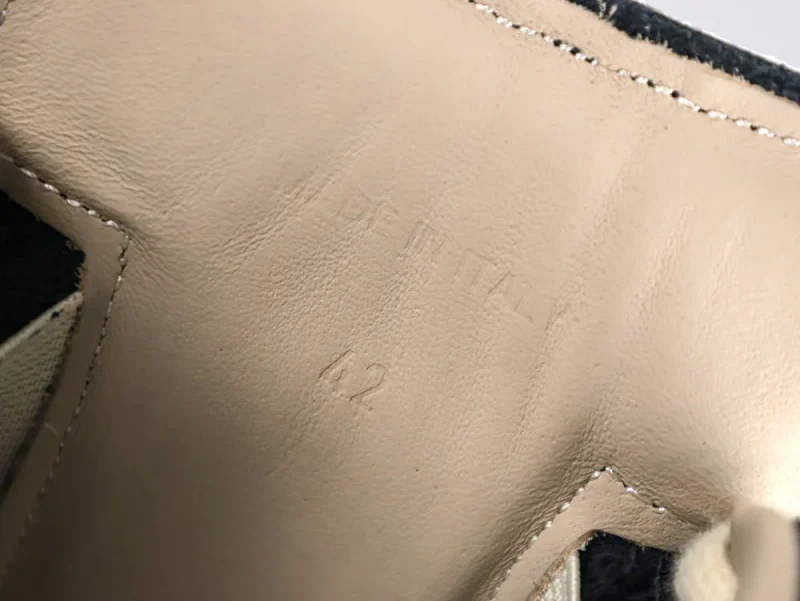 Light beige leather inside shoe, stitching detail, labeled "Made in Italy," size 42.