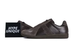Brown leather and suede sneaker with textured rubber sole, side view.