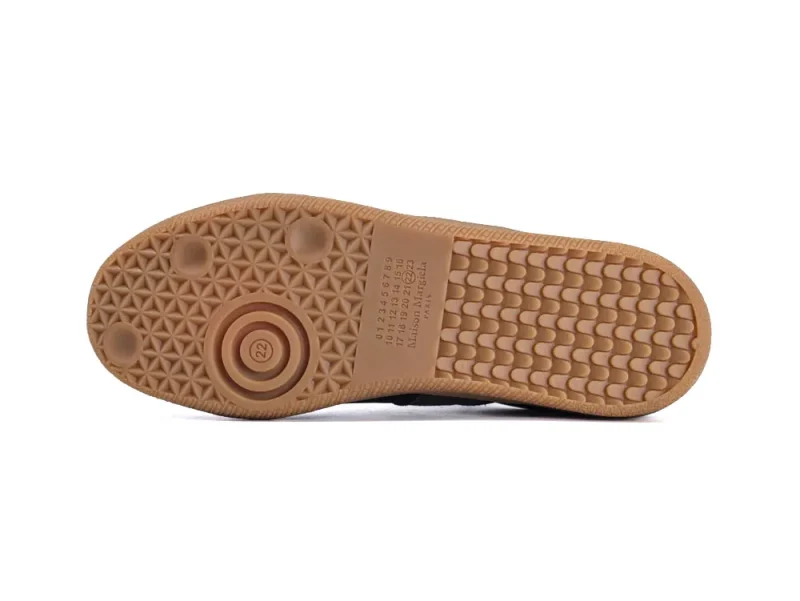 Beige rubber shoe sole with geometric patterns and textured grip surface.