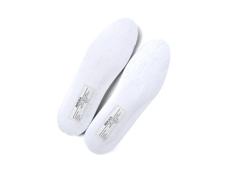 White rubber insoles with embossed texture and printed label detailing.