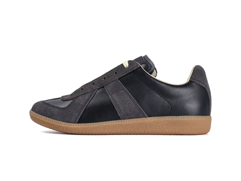 Dark gray leather and suede sneaker with a brown rubber sole, side view.
