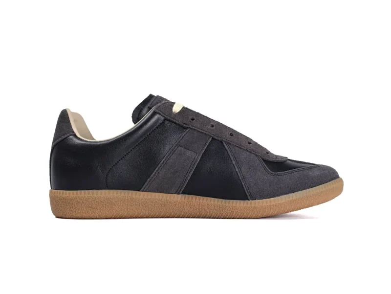 Black and gray leather sneaker with suede accents and tan rubber sole.