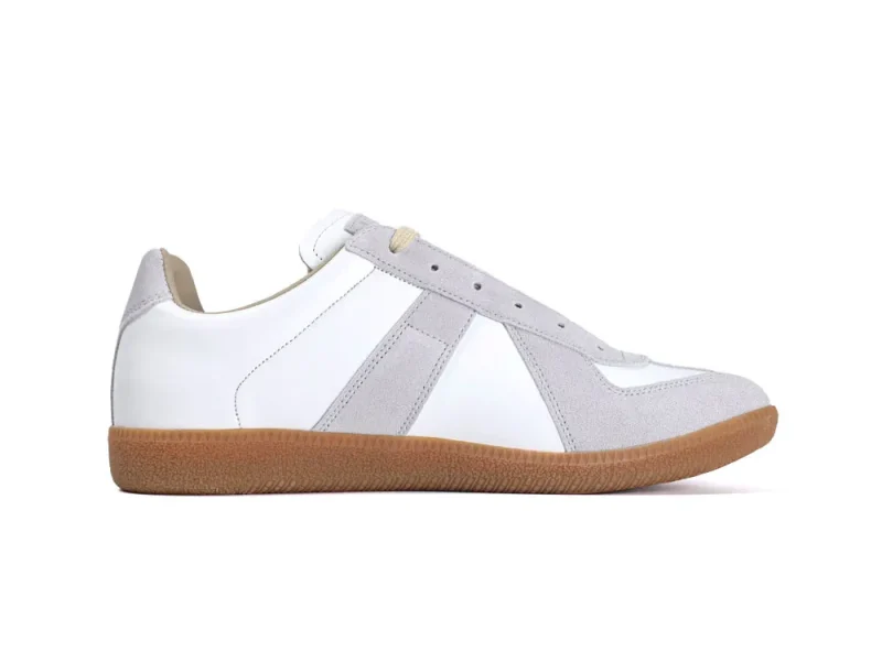 White leather sneakers with gray suede detailing and a brown rubber sole.