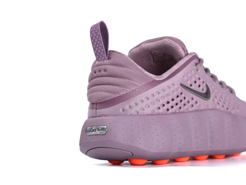 Purple mesh sneaker with rubber sole and orange accents on outsole.