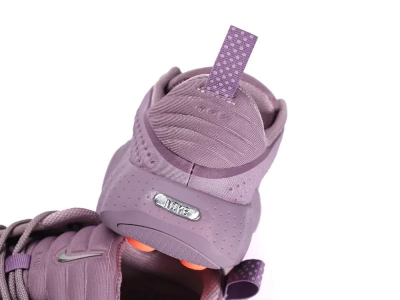 Lilac fabric sneaker heel with perforated design and silver logo accent.
