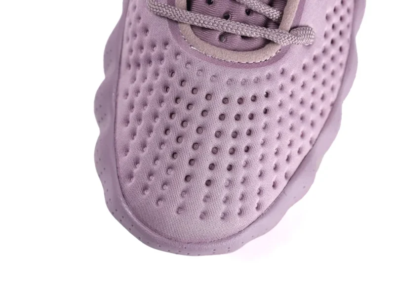 Perforated lavender fabric sneaker with textured sole and matching laces.