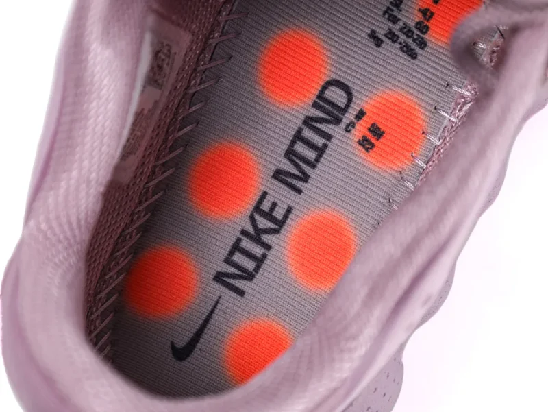 Lavender fabric sneaker interior with gray and orange insole featuring printed text.