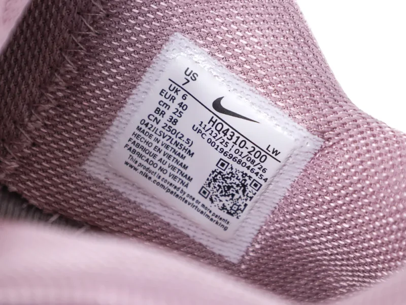 Pink mesh Nike shoe inner label with sizing and manufacturing details.