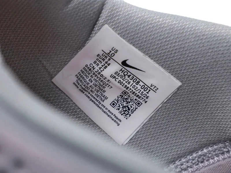 Gray fabric shoe interior with label and QR code.