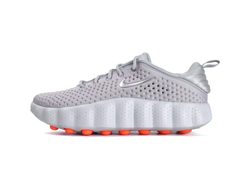 Gray perforated sneaker with a synthetic upper and orange cushioned sole.