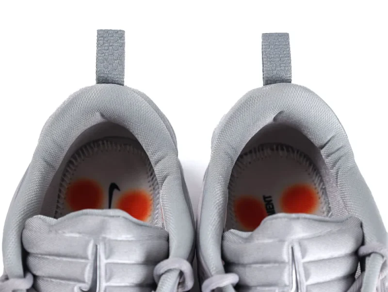 Gray fabric shoes with padded interiors and orange accented insoles.