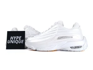 Side profile of sleek all-white sneakers showcasing wavy synthetic overlays and visible Air unit.