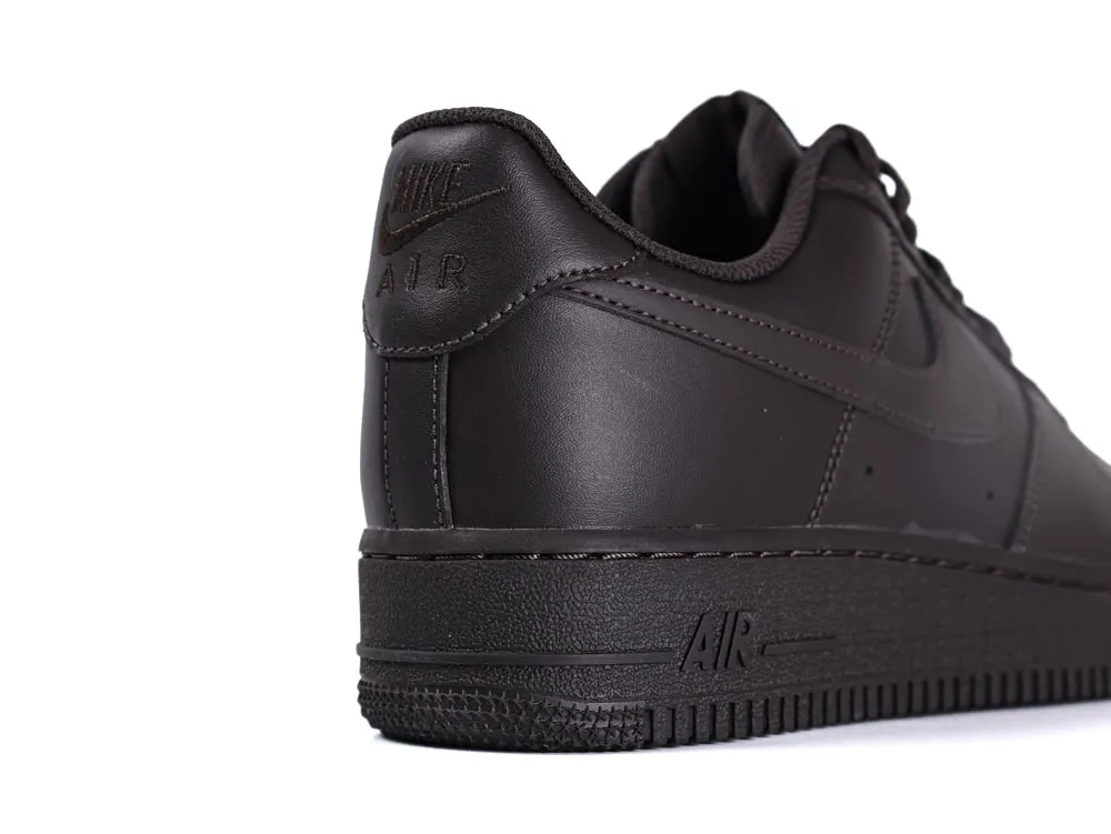 Dark leather shoe close-up, featuring embossed logo on the heel area.