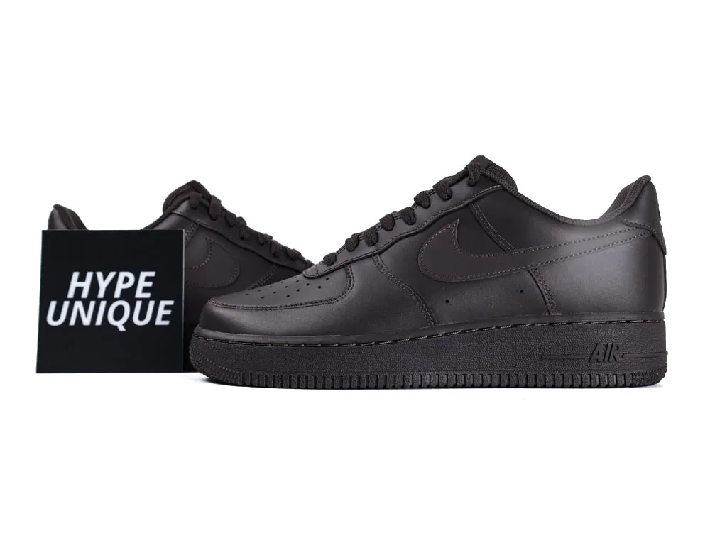 Dark brown leather sneakers with perforated toe box and textured outsole.