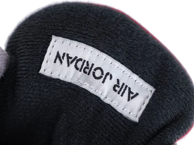 Black fabric tongue with white label featuring black text.