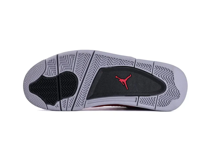 Gray and black rubber sneaker sole with detailed tread pattern and red logo.